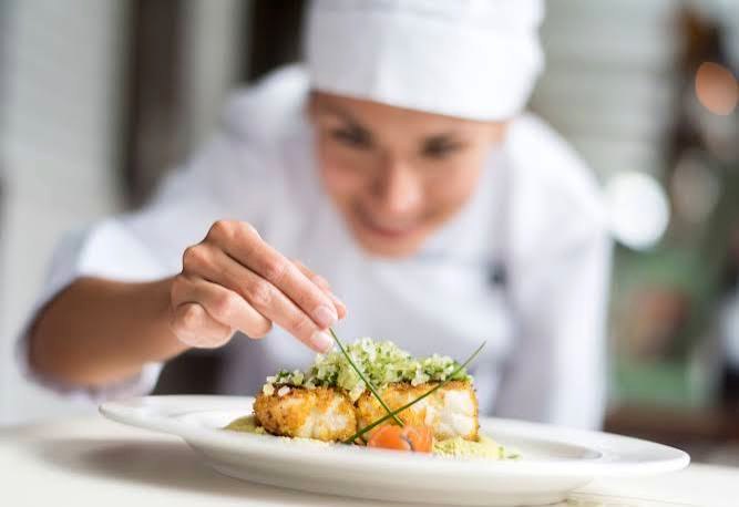 A chef plating a gourmet dish